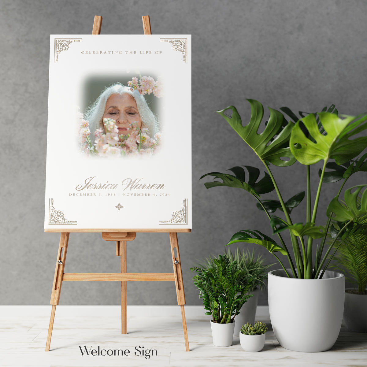 Funeral portrait print with ornate border, floral headpiece, and name text