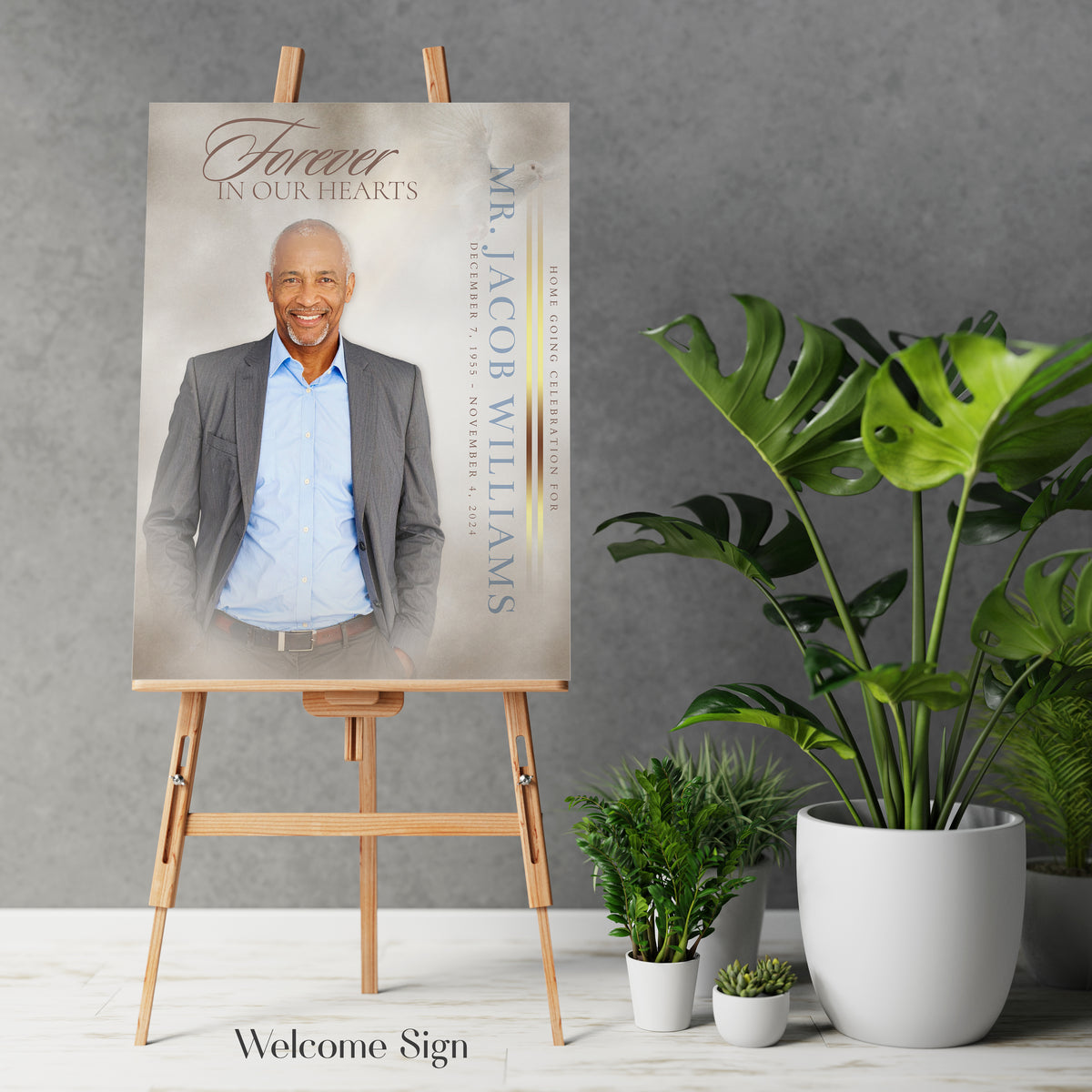 Funeral portrait print on easel with potted plants and display frame