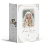 Obituary booklet open at an angle, featuring a centered floral portrait and ornate text frame.